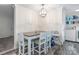 Bright dining area features white chair and table set, modern light fixture, and nearby laundry area at 1316 Wiscassett St, Albemarle, NC 28001