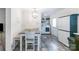 Bright dining area features modern light fixture, gray wood-look floors, and laundry area nearby at 1316 Wiscassett St, Albemarle, NC 28001