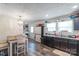 Bright kitchen with dark cabinets, stainless steel appliances, laminate countertop, laminate flooring, and eat in area at 1316 Wiscassett St, Albemarle, NC 28001