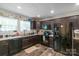 Modern kitchen with dark cabinets, stainless steel appliances, laminate countertop, and new laminate flooring at 1316 Wiscassett St, Albemarle, NC 28001