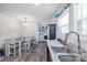 Bright kitchen with dark cabinets, stainless steel appliances, laminate countertop, new laminate flooring, and adjacent laundry area at 1316 Wiscassett St, Albemarle, NC 28001
