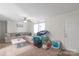 Bright living room with neutral walls, ceiling fan, large sectional sofa, and lots of natural light at 1316 Wiscassett St, Albemarle, NC 28001