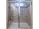Tiled walk-in shower with glass enclosure and rain shower head at 1316 Wiscassett St, Albemarle, NC 28001