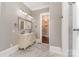 Elegant bathroom features a double vanity, marble floors, and a view into the spacious closet at 135 Waycross Dr, Rockwell, NC 28110