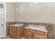 Bathroom features separate vanities with marble countertops and tile backsplash at 135 Waycross Dr, Rockwell, NC 28110