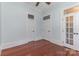 Bedroom with hardwood floors, light blue walls, white trim, and doors at 135 Waycross Dr, Rockwell, NC 28110