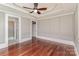 Primary bedroom with hardwood floors, decorative trim and an ensuite bathroom with glass shower at 135 Waycross Dr, Rockwell, NC 28110