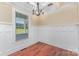 Dining room features hardwood floors, white wainscoting, and a chandelier at 135 Waycross Dr, Rockwell, NC 28110