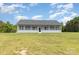 Exterior of a one-story home with a long porch and a large lawn at 135 Waycross Dr, Rockwell, NC 28110