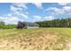 Beautiful single-story home with gray siding surrounded by a large green lawn and trees at 135 Waycross Dr, Rockwell, NC 28110