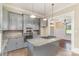 Modern kitchen with stainless steel appliances, gray cabinets, granite countertops, and tile backsplash at 135 Waycross Dr, Rockwell, NC 28110