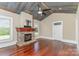 Living room with a metal ceiling, hardwood floors, and a stone fireplace at 135 Waycross Dr, Rockwell, NC 28110