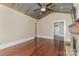 Spacious living room featuring hardwood floors, a stone fireplace, and a rustic metal ceiling at 135 Waycross Dr, Rockwell, NC 28110