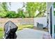 Landscaped backyard featuring a patio area and retaining wall, creating a tranquil and functional outdoor space at 1365 Eagle Claw Dr, Kannapolis, NC 28083