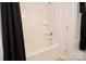Bright bathroom featuring a tub/shower with neutral tiling and black shower curtain at 1365 Eagle Claw Dr, Kannapolis, NC 28083