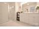 Bright bathroom featuring a glass door shower and a modern vanity with white cabinets at 1365 Eagle Claw Dr, Kannapolis, NC 28083