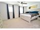 Bright bedroom with neutral decor, features a ceiling fan and large windows at 1365 Eagle Claw Dr, Kannapolis, NC 28083