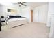 Bright bedroom with a ceiling fan, carpet, and a bed with a light wood frame at 1365 Eagle Claw Dr, Kannapolis, NC 28083