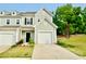 Inviting townhome featuring a well-manicured lawn and an attached one-car garage, providing both curb appeal and practicality at 1365 Eagle Claw Dr, Kannapolis, NC 28083