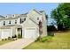 Charming townhome featuring a well-maintained lawn and an attached one-car garage, creating a welcoming curb appeal at 1365 Eagle Claw Dr, Kannapolis, NC 28083