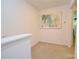 Bright hallway leading to a door with tan carpet and neutral paint at 1365 Eagle Claw Dr, Kannapolis, NC 28083