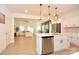 Bright, open-concept kitchen featuring stainless steel appliances, white cabinetry, and a spacious island overlooking the living area at 1365 Eagle Claw Dr, Kannapolis, NC 28083