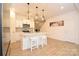 Well-lit kitchen features a center island with bar stool seating, stainless appliances, and modern lighting fixtures at 1365 Eagle Claw Dr, Kannapolis, NC 28083