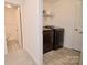 Well-lit laundry room with modern washer and dryer, plus shelving for storage at 1365 Eagle Claw Dr, Kannapolis, NC 28083