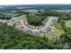 A high angle aerial view of a neighborhood surrounded by lush green trees at 14128 Morningate St, Huntersville, NC 28078