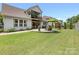 This home features a patio, a yard with green grass and a black fence to provide privacy and security at 14128 Morningate St, Huntersville, NC 28078