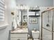 Cozy bathroom with granite countertop vanity, decorative shelves and a glass enclosed shower at 14128 Morningate St, Huntersville, NC 28078