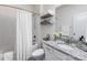 This bathroom boasts modern fixtures, a shower, a vanity with granite counter and decorative shelving at 14128 Morningate St, Huntersville, NC 28078