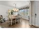 Elegant dining room with large window, chandelier, hardwood floors, and stylishly upholstered chairs at 14128 Morningate St, Huntersville, NC 28078