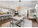 Inviting dining area with contemporary lighting and seamless access to the kitchen at 14128 Morningate St, Huntersville, NC 28078