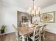 Charming dining area featuring a wooden table, decorative chandelier, and tasteful décor at 14128 Morningate St, Huntersville, NC 28078