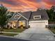 Beautiful home with a well-manicured lawn, long driveway, and a two-car garage at 14128 Morningate St, Huntersville, NC 28078