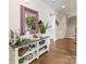 Inviting hallway featuring hardwood floors and a decorative console table with an ornate framed mirror at 14128 Morningate St, Huntersville, NC 28078