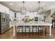 Stylish kitchen with white cabinetry, a large granite island with seating, and modern lighting fixtures at 14128 Morningate St, Huntersville, NC 28078