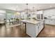 Open kitchen with granite island that flows into the dining area and living spaces at 14128 Morningate St, Huntersville, NC 28078