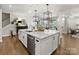 Kitchen featuring a large island with stainless steel appliances and hardwood floors at 14128 Morningate St, Huntersville, NC 28078