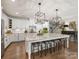 Modern kitchen featuring white cabinets, granite countertops, stainless steel appliances, and an island with seating at 14128 Morningate St, Huntersville, NC 28078