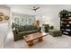 Spacious living room featuring a leather sofa, modern ceiling fan, and a view to an office at 14128 Morningate St, Huntersville, NC 28078