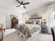 Comfortable main bedroom with modern ceiling fan, dresser, and a beautifully patterned bed at 14128 Morningate St, Huntersville, NC 28078