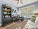 Comfortable home office with natural light, custom shelving, and a ceiling fan at 14128 Morningate St, Huntersville, NC 28078