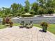 This patio is equipped with an umbrella, chairs and small tables and features some decorative plant life at 14128 Morningate St, Huntersville, NC 28078