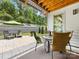 This patio offers a seating area with some chairs, a small glass table and an umbrella at 14128 Morningate St, Huntersville, NC 28078