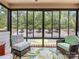 Inviting sunroom with comfortable wicker furniture, scenic views, and a patterned rug at 14128 Morningate St, Huntersville, NC 28078