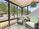 Relaxing sunroom with comfortable wicker furniture, scenic views, and a tropical patterned rug at 14128 Morningate St, Huntersville, NC 28078