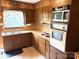 Classic kitchen with wood cabinets, a double sink under the window, and white appliances at 1460 Legion Rd, Fort Mill, SC 29715