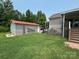 Backyard view of the house, a shed, and lawn care tools and equipment at 1545 Lewis Farm Rd, Kings Mountain, NC 28086